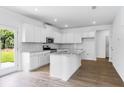 Bright, open kitchen featuring stainless steel appliances, granite countertops and hardwood floors at 213 Groveton Ct, Euharlee, GA 30145
