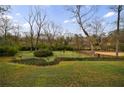 Spacious backyard featuring lush lawn and manicured garden beds providing a serene outdoor experience at 2544 Brookdale Nw Dr, Atlanta, GA 30305