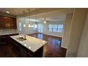 Open floorplan showing the kitchen with large island and the spacious living room with hardwood floors at 3285 Wild Basil Ln, Buford, GA 30519