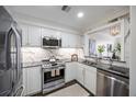 Updated kitchen with white cabinets, stainless steel appliances, granite countertops, and modern finishes at 75 14Th Ne St # 3830, Atlanta, GA 30309