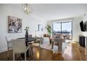Open-concept living and dining area with hardwood floors, modern decor, and access to a balcony at 75 14Th Ne St # 3830, Atlanta, GA 30309