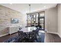 Dining room with an oval marble table, contemporary light fixture, and a brick accent wall at 103 Birch St, Decatur, GA 30030
