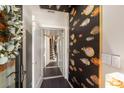 Hallway with dark hardwood floors, colorful fish wallpaper, white trim, and access to stairs and an elevator at 103 Birch St, Decatur, GA 30030