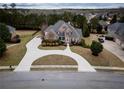 Aerial view of a beautiful home, circular driveway and well maintained landscaping at 912 Fire Thorn Dr, Hampton, GA 30228