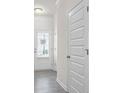 Bright hallway with plank flooring and paneled doors at 313 Skye Ln # 49, Cartersville, GA 30121