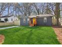 Charming home with gray siding, a bright yellow front door, and lush green lawn at 4179 Hanes Dr, Decatur, GA 30035