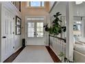 Entryway featuring natural light, soaring ceilings, hardwood floors and staircase at 7115 Harbour Lndg, Alpharetta, GA 30005