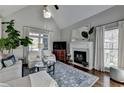 Bright living room boasts vaulted ceilings, fireplace, large windows, and hardwood flooring at 7115 Harbour Lndg, Alpharetta, GA 30005