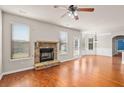 Spacious living room featuring hardwood floors, a stone fireplace, and stylish trim at 1645 Renfroe Run, Cumming, GA 30041