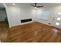 Open living room with hardwood floors, a modern fireplace, and recessed lighting at 4430 Locksley Rd, Tucker, GA 30084
