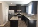 Modern kitchen with stainless steel appliances and granite countertops at 849 Arbor Crowne Dr, Lawrenceville, GA 30045
