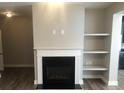 Cozy living room showcasing a fireplace and built-in shelves at 849 Arbor Crowne Dr, Lawrenceville, GA 30045