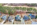 A bird's eye view shows homes with backyard pools bordering the manicured lawns of a golf course at 151 Creek Bank Dr, Acworth, GA 30101