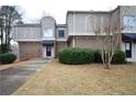 Attractive townhome with brick and stucco exterior, neat landscaping, walkway leading to the front door offer curb appeal at 3301 Henderson Mill Rd # F1, Atlanta, GA 30341