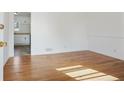 Bright living room with hardwood floors and view to the kitchen and an abundance of natural light at 5205 Dunmoreland Ct, Atlanta, GA 30349