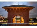 Architectural detail with arched window, brickwork, and city view in the background at 170 Boulevard Se # H523, Atlanta, GA 30312