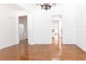 Open-concept living room featuring hardwood floors and neutral paint at 3277 Wyesham Cir, Duluth, GA 30096