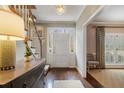Welcoming foyer with hardwood floors, a decorative chandelier, and views of the staircase and living areas at 2385 Hanover West Ln, Atlanta, GA 30327