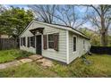 Cozy home with light green siding, dark shutters, and simple landscaping on a sunny day at 3020 Harold Se Ave, Atlanta, GA 30316