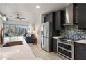 Sleek kitchen featuring stainless steel appliances, dark cabinetry, and an open view to the living area at 923 Peachtree Ne St # 930, Atlanta, GA 30309