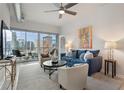 Cozy living room with a comfortable blue sofa, stylish decor, and a balcony overlooking the city at 923 Peachtree Ne St # 930, Atlanta, GA 30309