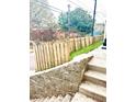 Stone staircase leads up to a wood fence, adding privacy to the property at 971 Martin Se St, Atlanta, GA 30315