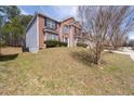 A brick two-story house featuring a well-maintained lawn and blue siding accents at 7178 Cavender Sw Dr, Atlanta, GA 30331