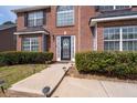 Up close view of a home's front door, complemented by manicured bushes and walkway at 7178 Cavender Sw Dr, Atlanta, GA 30331