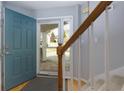 View of the entryway with a teal front door and staircase at 633 N Fairfield Dr, Peachtree City, GA 30269