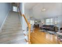 Open living room with vaulted ceilings, hardwood floors, and a staircase at 633 N Fairfield Dr, Peachtree City, GA 30269