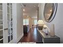 Spacious hallway featuring dark hardwood floors, a console table, and access to the living room at 1116 Heatherland Dr, Marietta, GA 30066