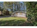 Side view of single-story home with gray brick and an attached carport at 1702 Danrich Dr, Decatur, GA 30032