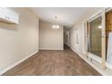 Living area with wood-look flooring, neutral walls, and modern light fixture at 1702 Danrich Dr, Decatur, GA 30032