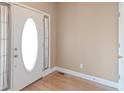 Bright entryway featuring an oval glass front door, and hardwood floors, creating a welcoming entrance at 313 Sable Trace Pass, Acworth, GA 30102