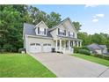 Lovely two-story home features a two-car garage, covered entry and neatly maintained lawn at 313 Sable Trace Pass, Acworth, GA 30102