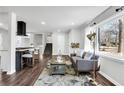 Cozy living room showcases an open-concept, hardwood floors, modern furnishings, and plenty of natural light at 1785 Hammond Woods Sw Cir, Marietta, GA 30008