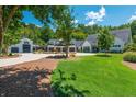 Expansive property showing the home's exterior, three car garage, and lush green lawn at 201 Edwards Brook Ct, Canton, GA 30115