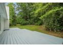 A well-maintained back deck with a view of the lush and well-maintained backyard creates a relaxing retreat at 5936 Old Wellborn Trce, Lithonia, GA 30058