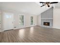 Inviting living room boasts a fireplace, vaulted ceiling and abundant natural light at 3807 Memorial Nw Pkwy, Kennesaw, GA 30152