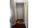 Neutral hallway features a white front door and hardwood floors at 398 Kyles Cir, Hiram, GA 30141