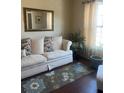 Cozy living room featuring a striped sofa and a large mirror at 398 Kyles Cir, Hiram, GA 30141