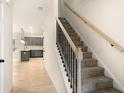 Carpeted staircase with decorative black iron spindles and light wood handrail leading to the upper level at 712 Shetland Trl, Cartersville, GA 30121