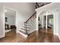 Elegant foyer with hardwood floors, staircase, and an arched entryway to the living room at 4441 Langdon Se Walk, Smyrna, GA 30080