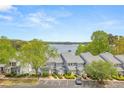 Scenic aerial view of townhomes showcasing lake view, parking, and lush greenery for a tranquil living environment at 2300 Habersham Marina Rd # 201, Cumming, GA 30041