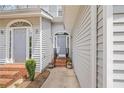 Exterior entrance of townhome, highlighting the front door, potted plants, and well-maintained walkway at 2300 Habersham Marina Rd # 201, Cumming, GA 30041