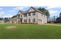 Expansive two-story home featuring a well-manicured lawn and convenient side-entry garage at 701 Cupcake Ct, Mcdonough, GA 30252