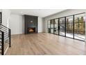 Spacious living room with a fireplace, and access to a covered back porch at 128 Owens Mill Pl, Canton, GA 30115