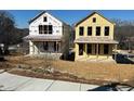 Exterior of two new construction houses, one with siding and the other with wrapped walls at 1919 Repose Dr, Chamblee, GA 30341