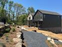 Home with modern curb appeal and gravel driveway at 1919 Repose Dr, Chamblee, GA 30341