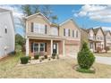 Two-story home with neutral siding, brick-accented facade, and a well-manicured front yard with landscaping at 2248 Newbury Oaks Dr, Lawrenceville, GA 30044